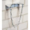 Metal fire extinguisher bracket on brick wall. Chain to secure the fire extinguisher.