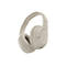 Casque supra-auriculaire sans fil beige sur fond blanc. Le fabricant Belkin est visible sur le bandeau.
