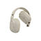 Casque beige flottant sur fond blanc. Oreillettes, arceau et commandes, dont le bouton ANC, sont visibles.