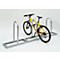 Yellow bicycle in a metal bike rack. The rack has a rectangular shape with three supports.