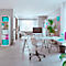 Espace de travail lumineux et moderne avec bureau, chaise de bureau, étagères et canapé. Plantes vertes et décoration.