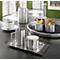 Stainless steel coffee service with cups, sugar bowl, and serving dishes, all set on a table.