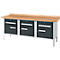 Workbench with wooden top, three drawers, silver handles and silver legs.