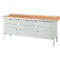 Workbench with light brown wooden top and light gray drawers. Standing on metal legs.