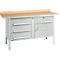 Workbench with wooden top and drawers in gray. The drawers have silver handles.