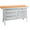 Metal workbench with light brown wooden top and silver drawers.