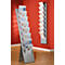 Two silver brochure stands with brochures in front of a red wall. The right stand is mounted on the wall.