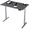 Un bureau gris réglable en hauteur avec un plateau de table sombre. Dessus : tablette, porte-papier et papier.