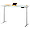 Bureau gris réglable en hauteur avec plateau clair. Il y a un plateau, une tablette et une agrafeuse sur le bureau.