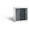 White filing cabinet with gray roller shutters, two interior shelves and black handles. Shadow on the left.