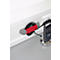 A grey cable holder with a red holder, to which a black cable is attached. Next to it a mobile phone in a charging cradle.