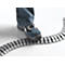 A foot in jeans and safety shoe stands on a gray cable duct.
