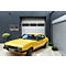 Un coupé vintage jaune garé sur une allée pavée devant une porte de garage moderne avec des fenêtres.