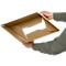 Person holding an open, brown cardboard box.