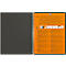 Cahier à spirale ouvert, couverture gauche grise, couverture droite orange avec texte et graphiques.