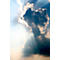 Sunbeams break through dark clouds. Bright light and shadow create a dramatic effect.
