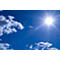 Blue sky with sun and clouds. The sun shines brightly, surrounded by rays of light.