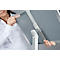 Person adjusting a grey presentation surface on a white tripod.