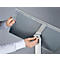 Hands attaching a gray sign to a metallic stand. Detailed close-up.