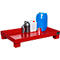 Red spill containment tray with canisters and a barrel.