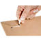 A hand is opening a brown envelope, with a white strip at the opening.