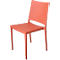 A single, coral-colored chair standing against a white background.