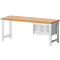 Workbench with wooden top and drawers. Light gray legs, wood-colored tabletop. Drawer unit with three drawers.