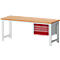Workbench with wooden top and red drawers. It stands on white metal legs.
