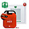 Roter AED-Defibrillator mit Griff, daneben ein Schild mit Herzsymbol und Alarm-Icon.