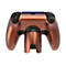 Kupferfarbener Gaming-Controller mit Rücktasten-Aufsatz vor weißem Hintergrund.