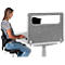 Woman typing at desk. Gray privacy screen with window on table.