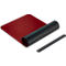Red, unrolled desk pad with black roll and wrist rest.