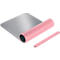 Gray mousepad, partially rolled up. Next to it a pink wrist support.