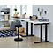 A height-adjustable desk with a laptop and chair in a bright office. On the table are folders and office supplies.