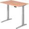 An adjustable height desk with a wooden top and a gray frame. On the tabletop is a black control panel.