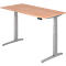 A height-adjustable desk with a wooden top and silver legs. It has a control panel.