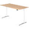 A height-adjustable desk with a light brown tabletop and white frame. Black control panel.
