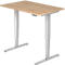 A height-adjustable desk with a light brown table top and silver legs. Control panel for height adjustment.