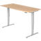 A height-adjustable desk with light brown tabletop and silver legs against a white background.