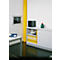 Office with white cabinet, yellow folders, artwork, and blue phone.