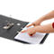 Hands pointing at paper in black binder, metallic clasp.