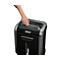 A person's hand resting on a black paper shredder. It says "Fellowes".