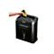 A person pours shredder oil into a black Fellowes brand paper shredder. The hand holds a yellow bottle.