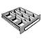 Open drawer with multiple compartments. A silver bar acts as a handle.