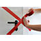 Hands taping a door with red tape. Black door handle.