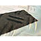 Dark grey, rough material against a smooth, light background. The material has a crumpled surface.