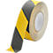 A roll of yellow and black anti-slip tape. The tape is rolled up and partially unrolled, revealing the striped pattern.