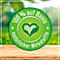 Green sticker with heart-leaf symbol, text: 100% based on natural ingredients. Lying on a wooden surface.