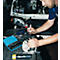 Mechanic working on a car, using a pen. Tools are on the table.