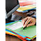 A person is writing on a green folder. Underneath are other stacks of colored folders, a computer and a cell phone are in the background.